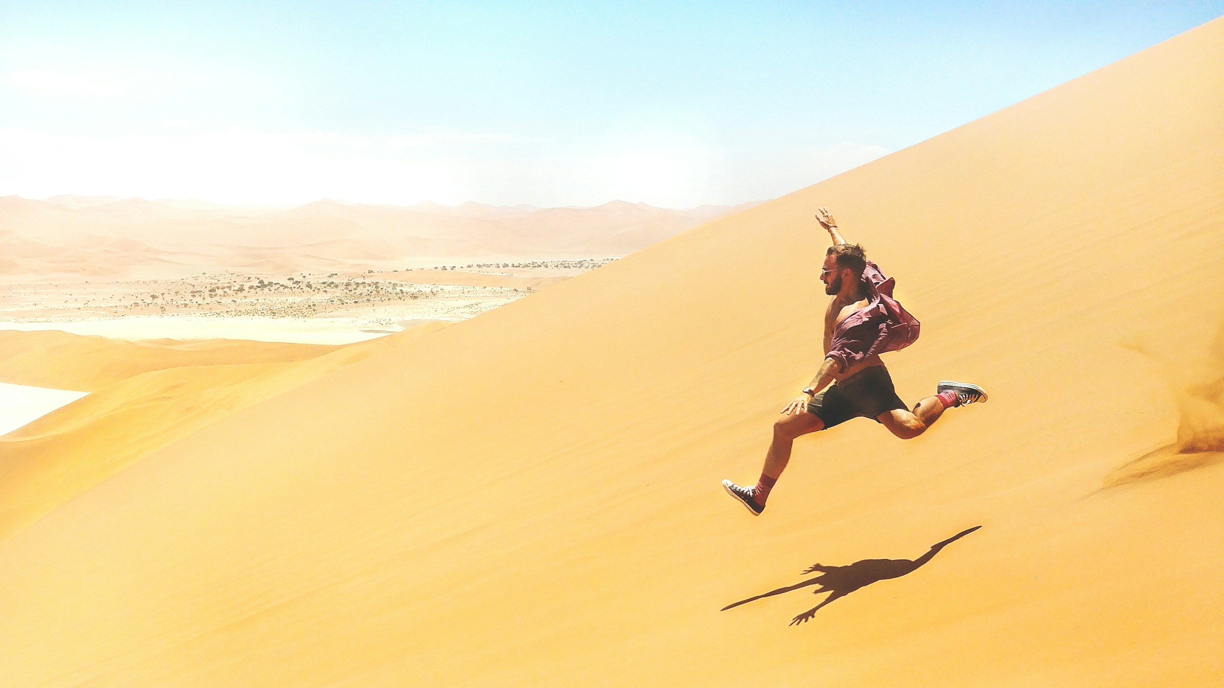 Runner moving across desert dunes